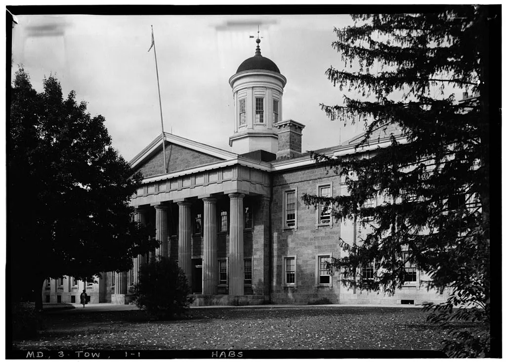 Historic black-and-white view of the Baltimore County Courthouse in Towson, with a columned entrance and cupola.
