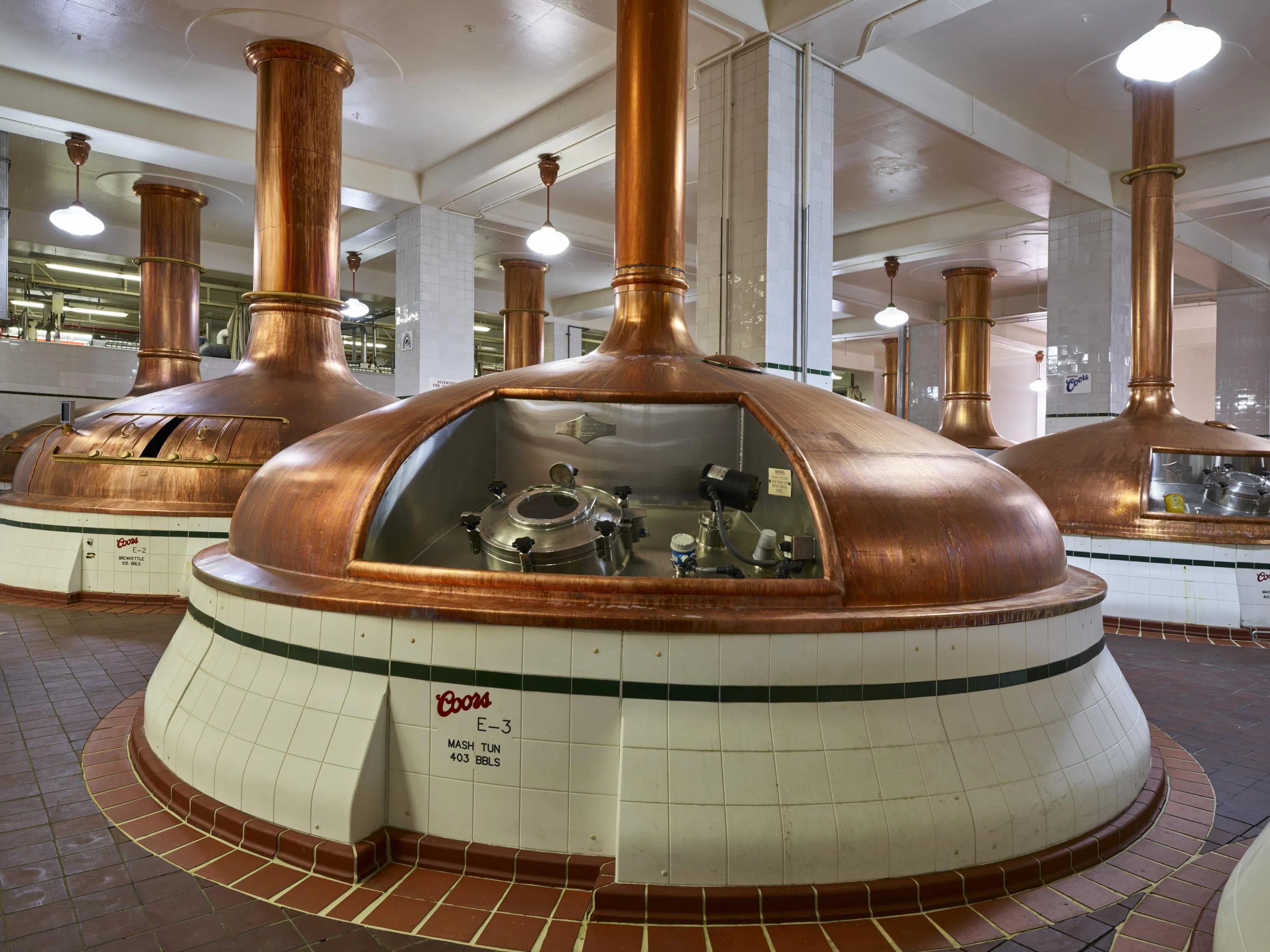Rows of large metal brewhouse kettles at the brewery in Golden, photographed in 2016