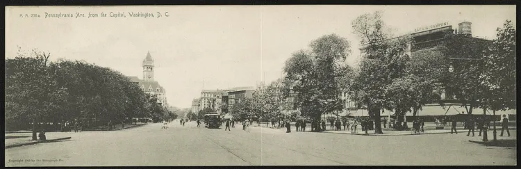Panoramic historic postcard looking west along Pennsylvania Avenue in Washington, with a streetcar, pedestrians, trees and commercial buildings.