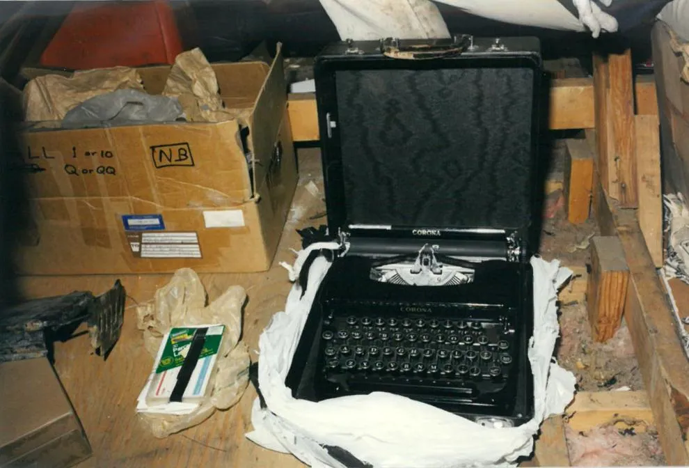 Black Corona typewriter in its case among boxes and other belongings in Kaczynski’s cabin.